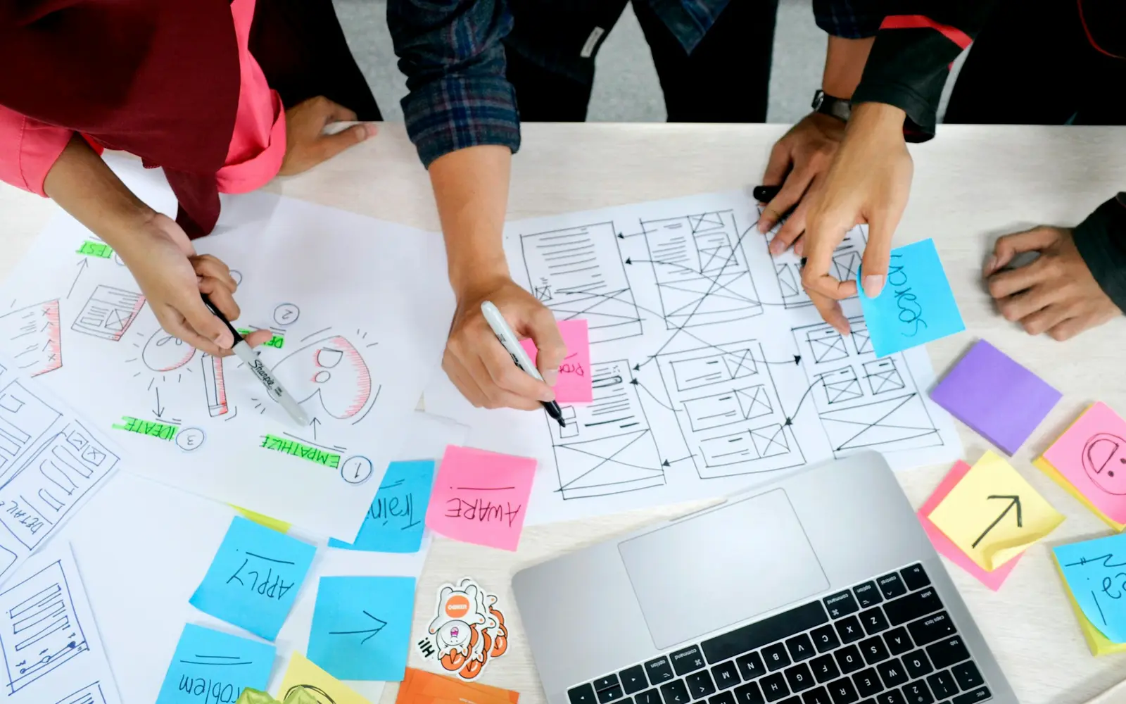 A web design team planning a website redesign with sketches and notes